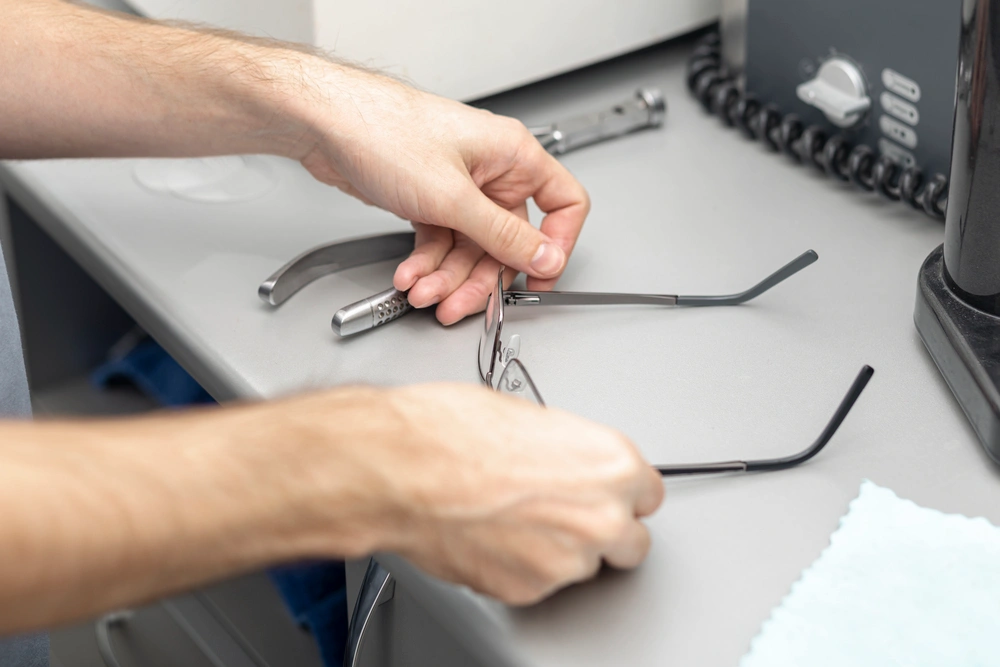 high-angle-man-putting-down-his-glasses-desk opti